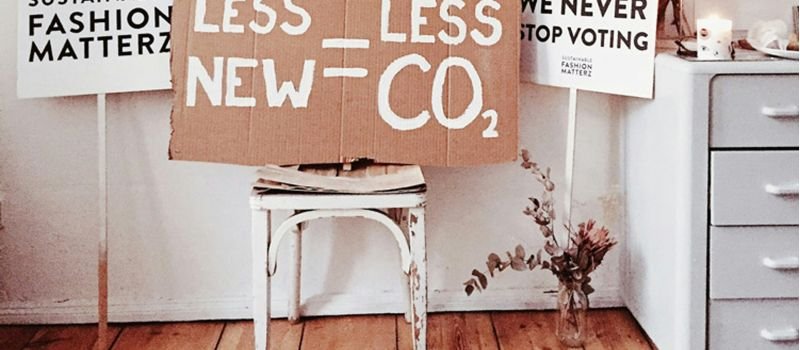 a chair with banner on less new = less CO2